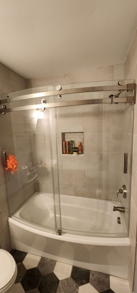 Tile shower with bathtub and glass door